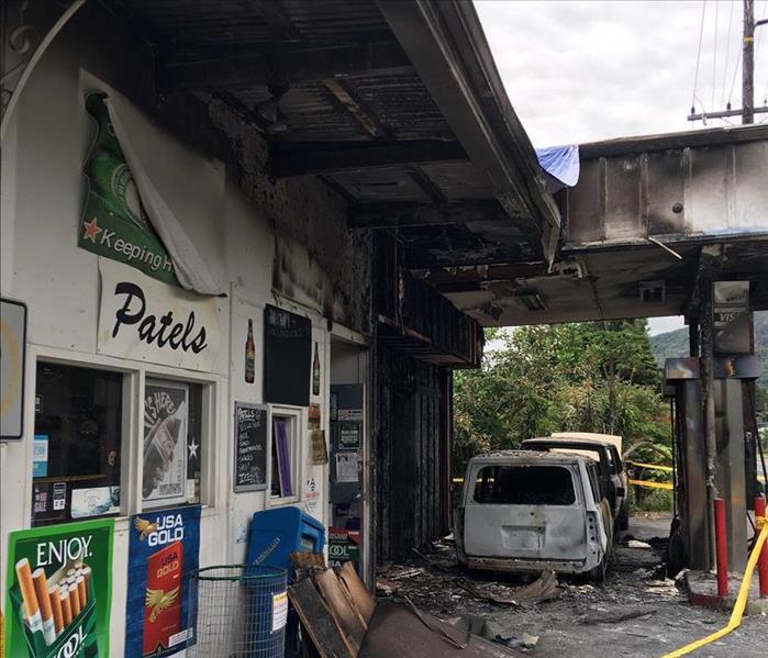Side of the gas station with doors and windows affected with fire damage