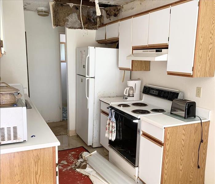 Kitchen area with fallen ceiling due to water damage